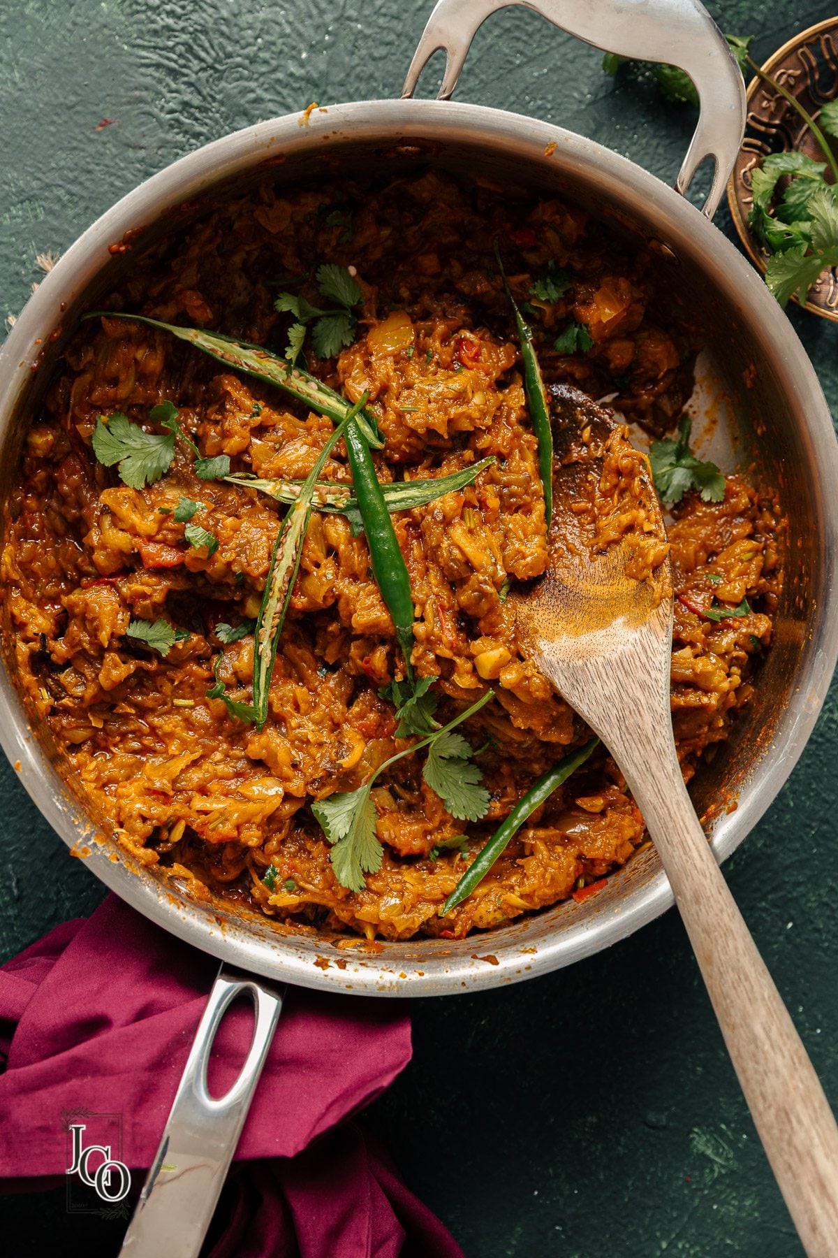 baingan bharta in a pan with a serving spoon.