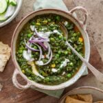 Cream drizzled on spinach curry in a serving bowl.