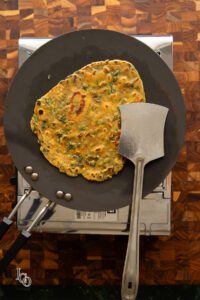 Roasted methi paratha on a hot tawa.