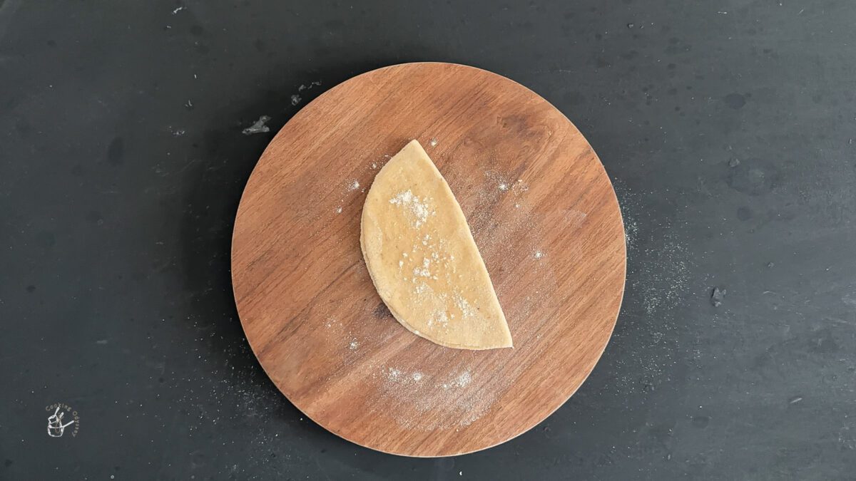 half folded rolled dough spread with oil and flour.
