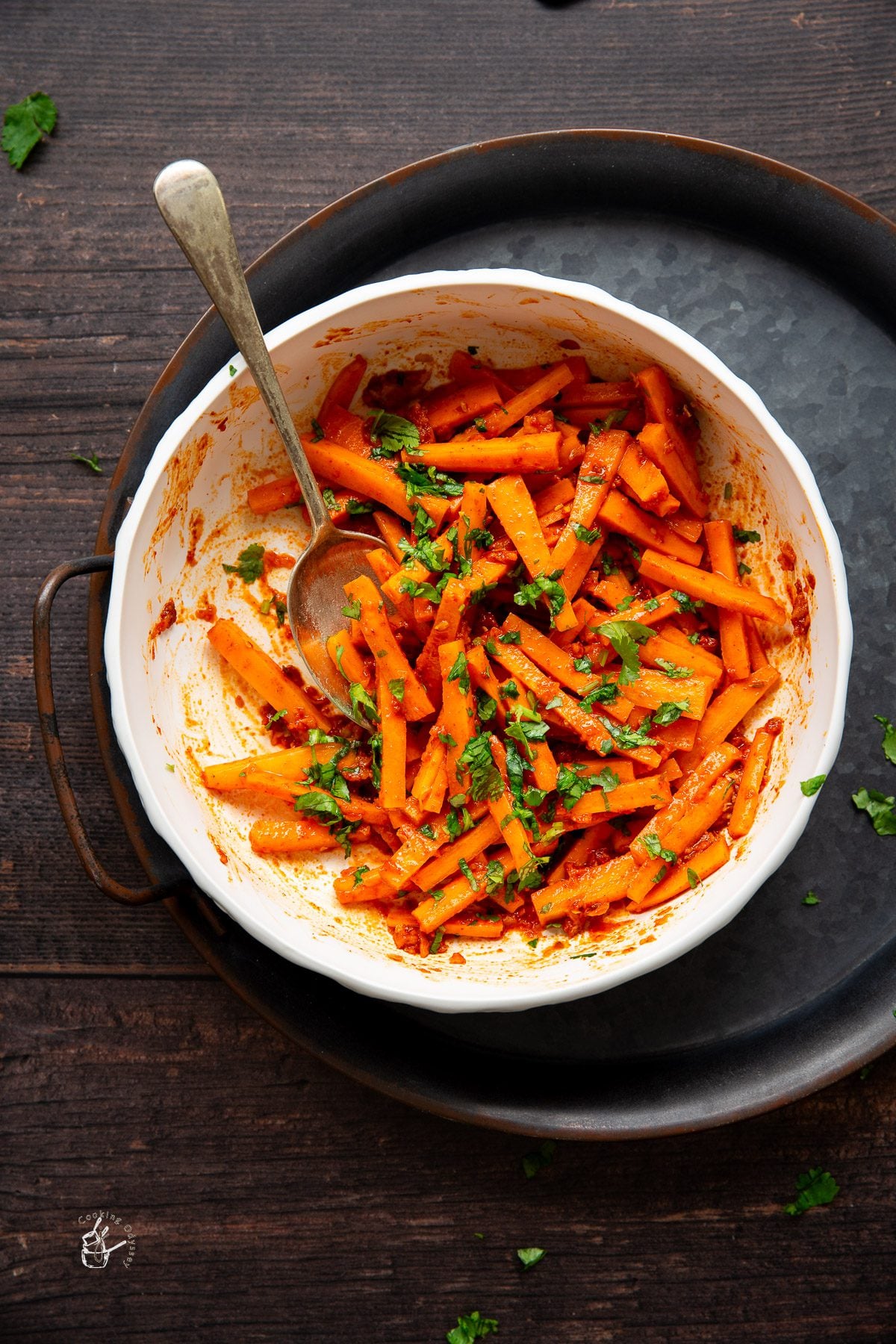 garlic carrots are served in a white small bowl.