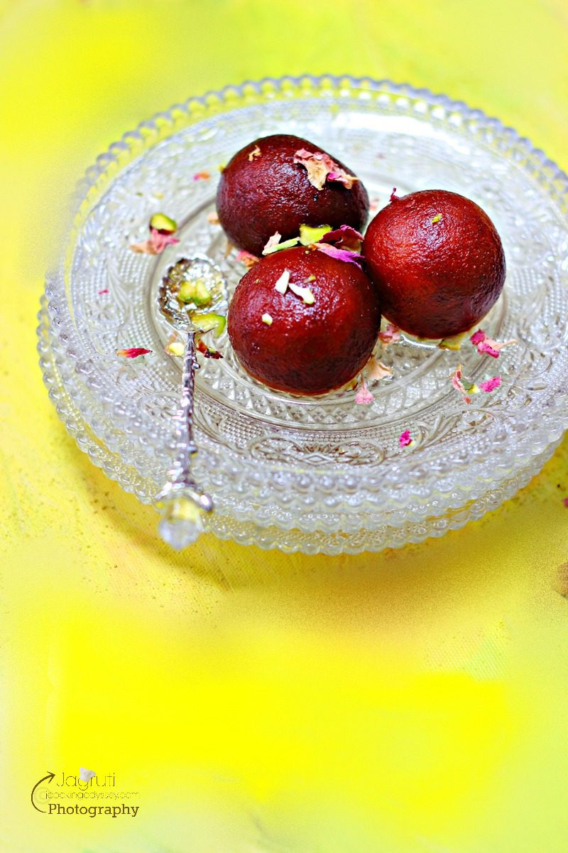 Channar Puli - Paneer Gulab Jamun in a plate with a spoon