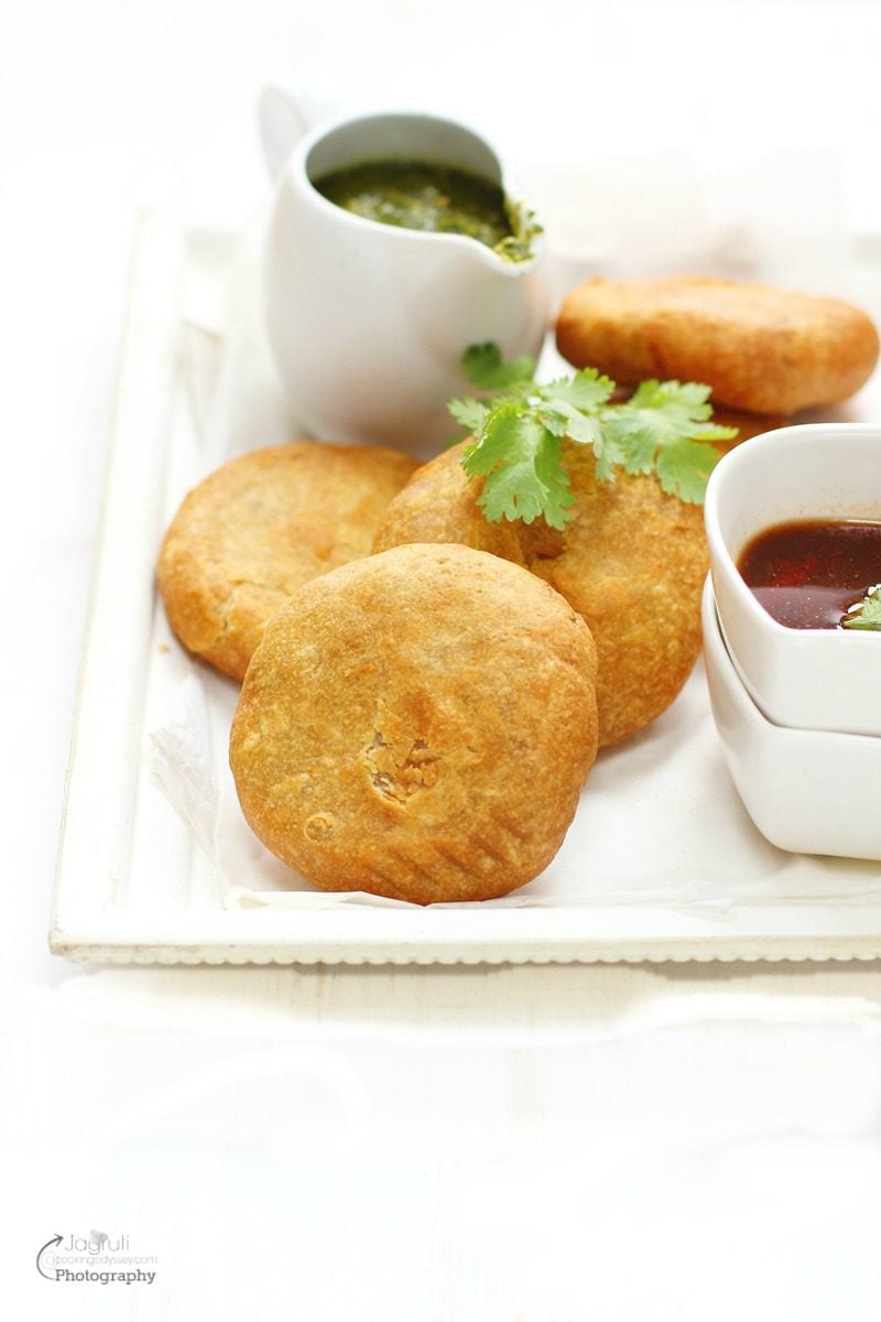 aloo matar kachori served in a white tray with tamarind chutney