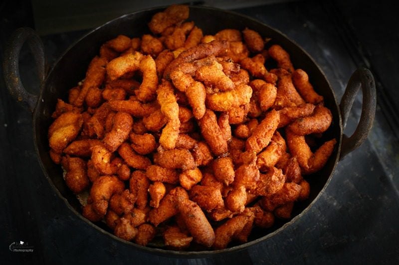 a bowl filled with masala fulwadi placed on a black backdrop