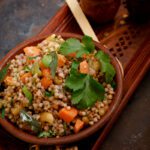 Farali buckwheat upma served in a small wooden bowl and placed on a wooden tray