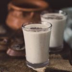 two glasses filled with off white coloured raabdi