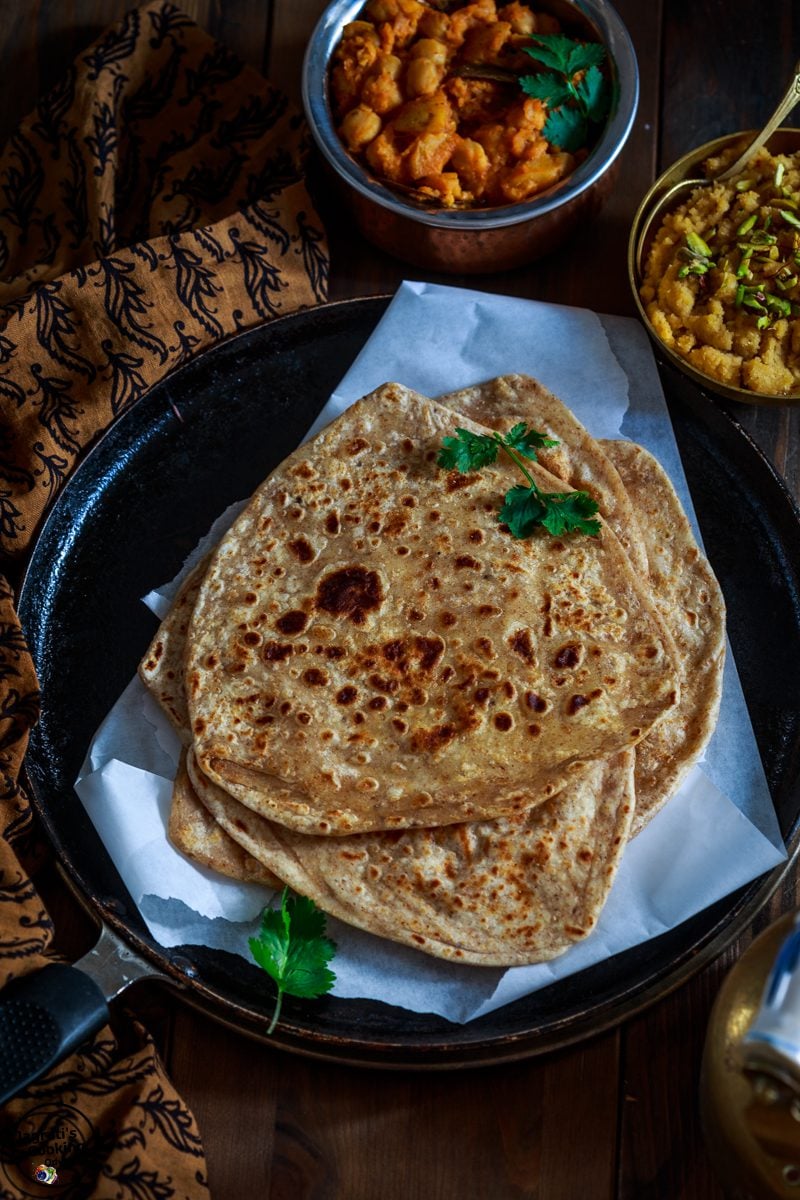 Coconut milk doodh paratha stacked on a plate