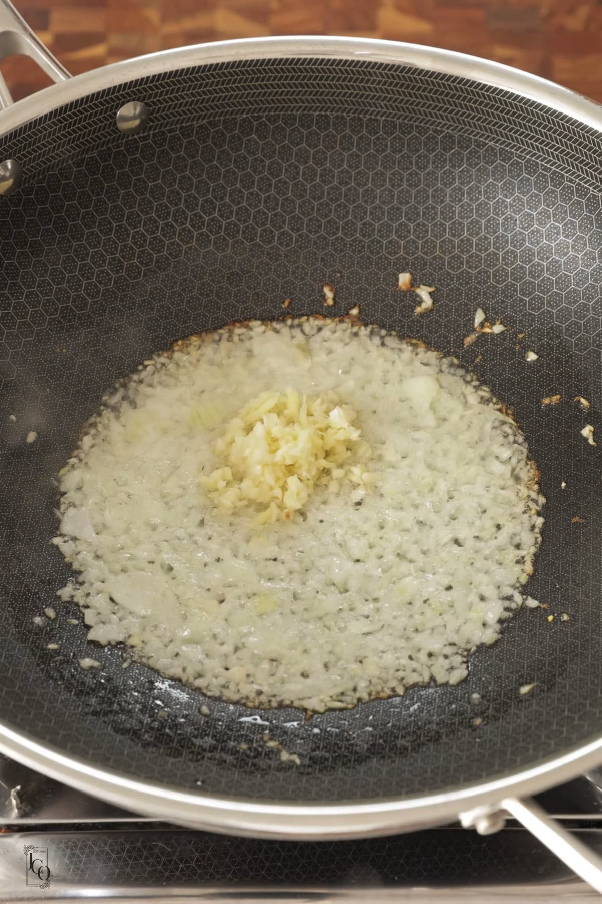 Finely chopped onions cooked in a pan with ginger and garlic.