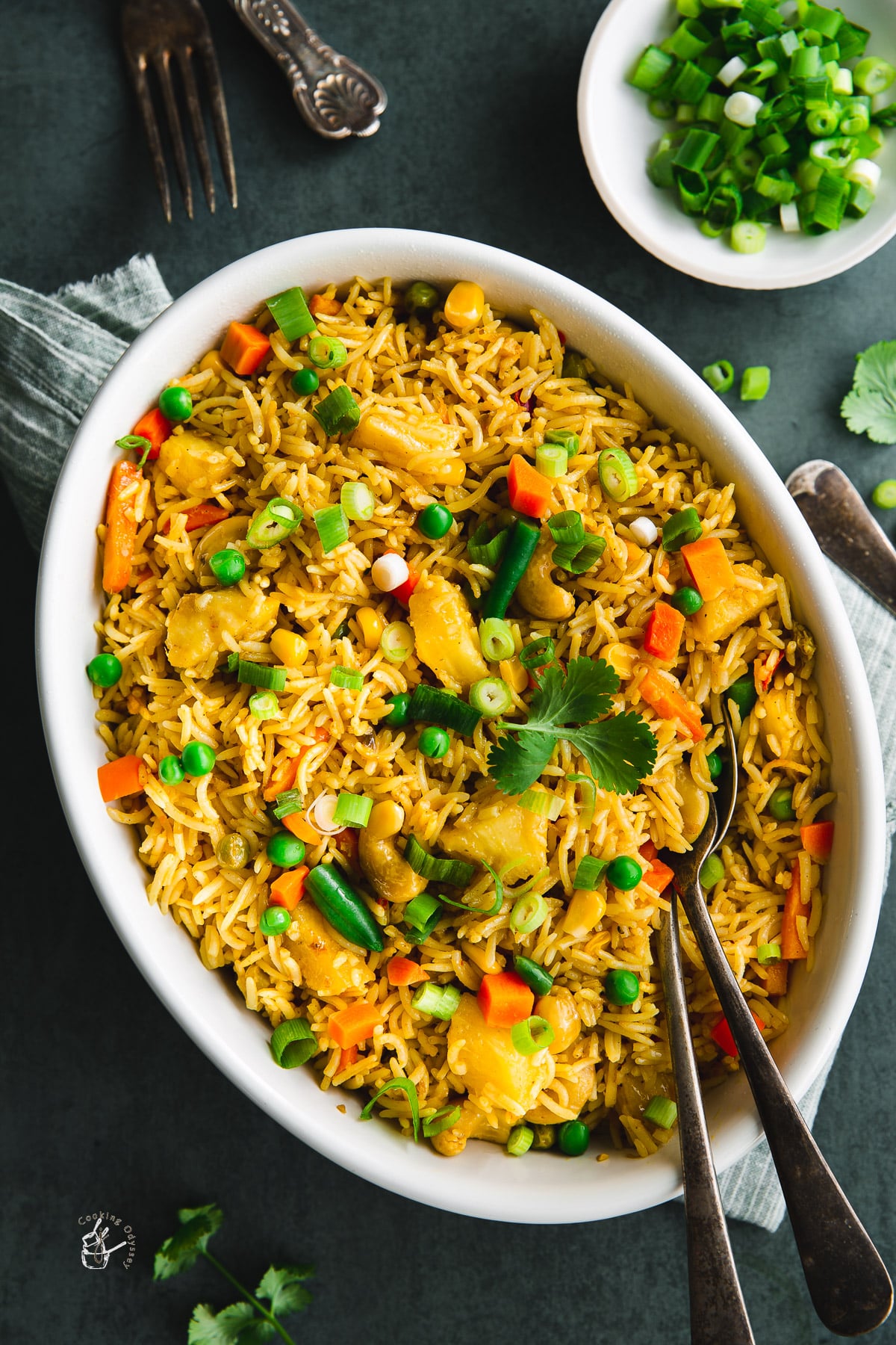 Thai pineapple fried rice garnished with chopped green onions.
