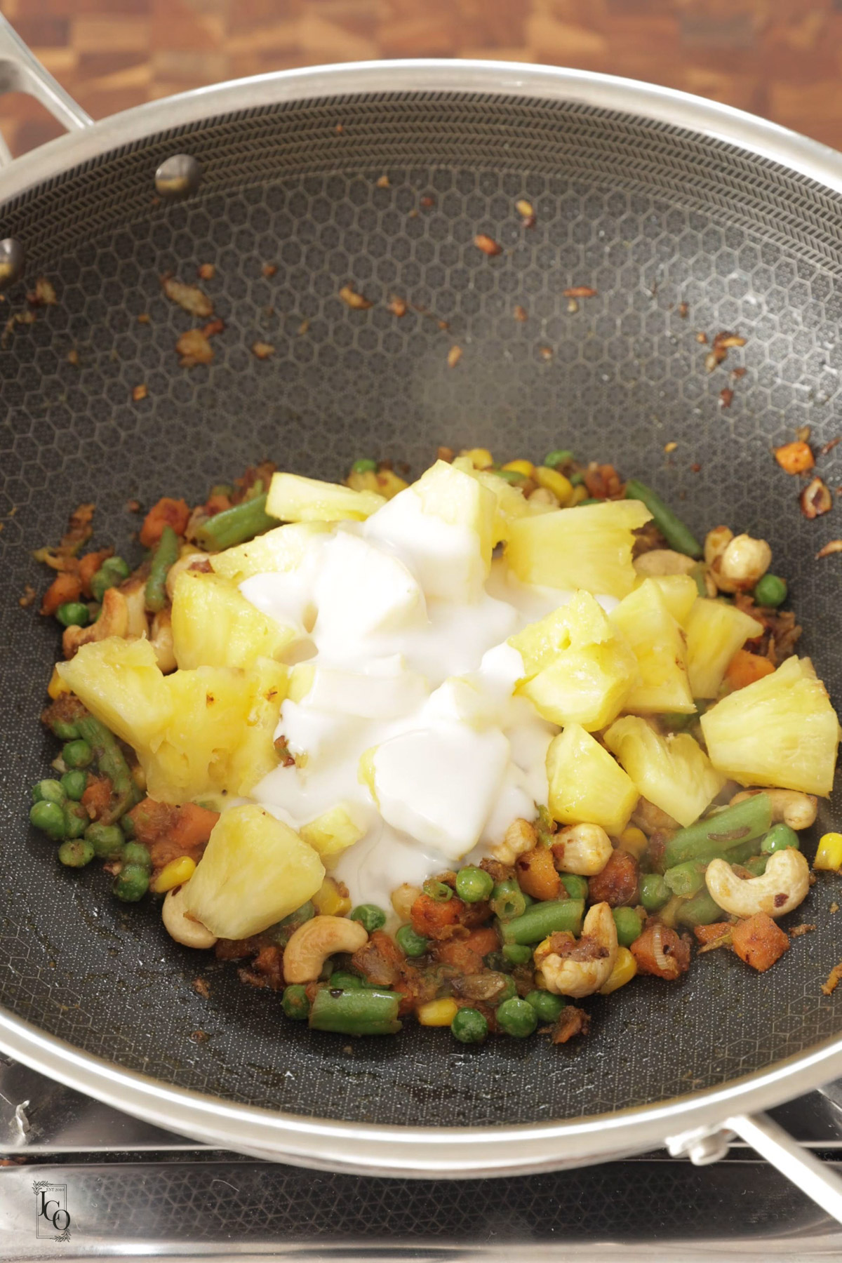Fresh pineapple and coconut milk added to cooked mixed veggies.