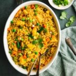 Vegan thai fried rice served in an white oval serving dish.
