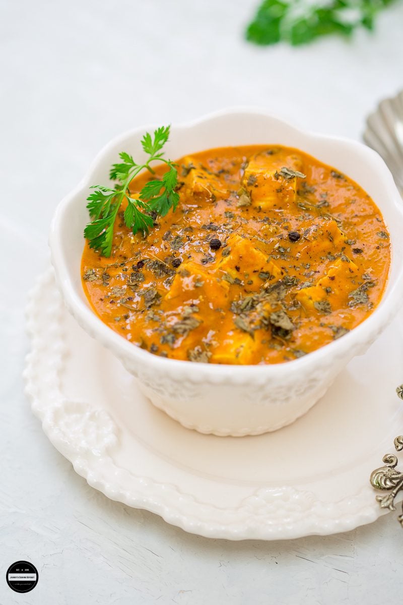 Tofu dum kali mirch served in a serving bowl with a serving spoon