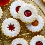 An image of eggless linzer cookies laid on a cooling wire rack