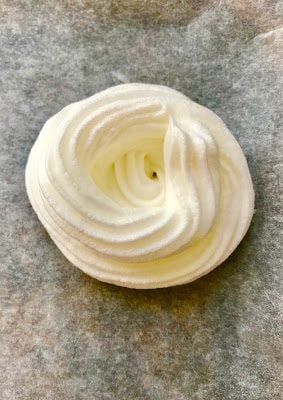 a single cooked vegan meringue on parchment paper.