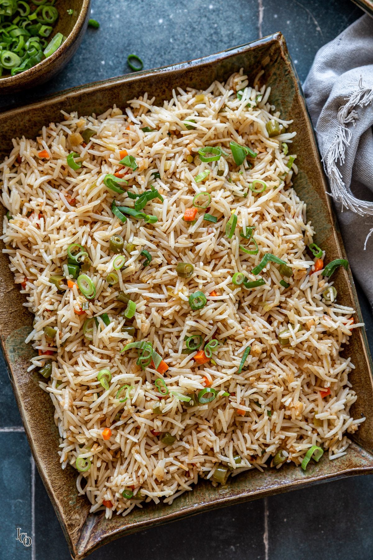 Fried rice garnished with finely chopped spring onions. 