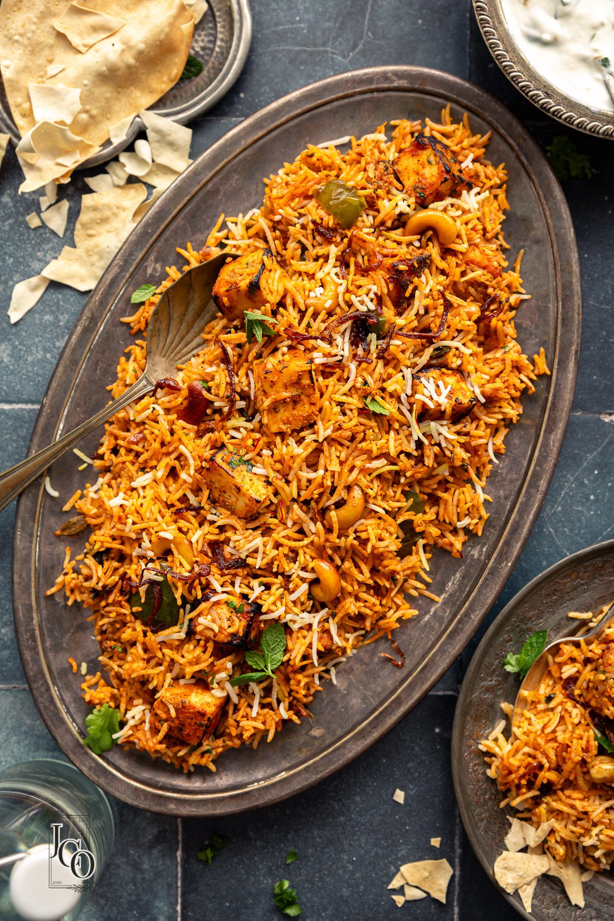 Biryani topped with tandoori paneer tikka.