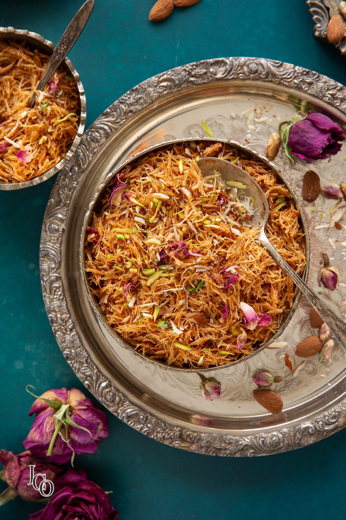 South Indian dessert, served in two decorative serving bowls with serving spoons.