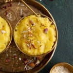 Two gold bowl of coconut halwa placed on a round thali.