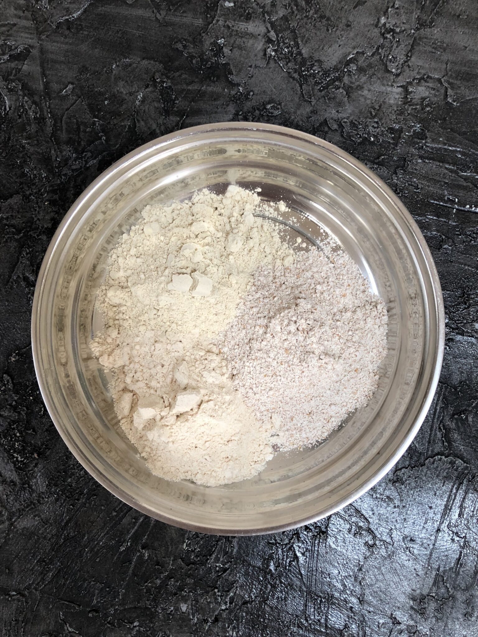 Mixed grain flours in a stainless steel bowl. 
