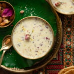 A bowl of basundi placed on a round brass plate.