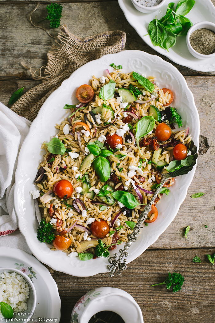 This delicious pasta salad is served in a oblong white platter. 