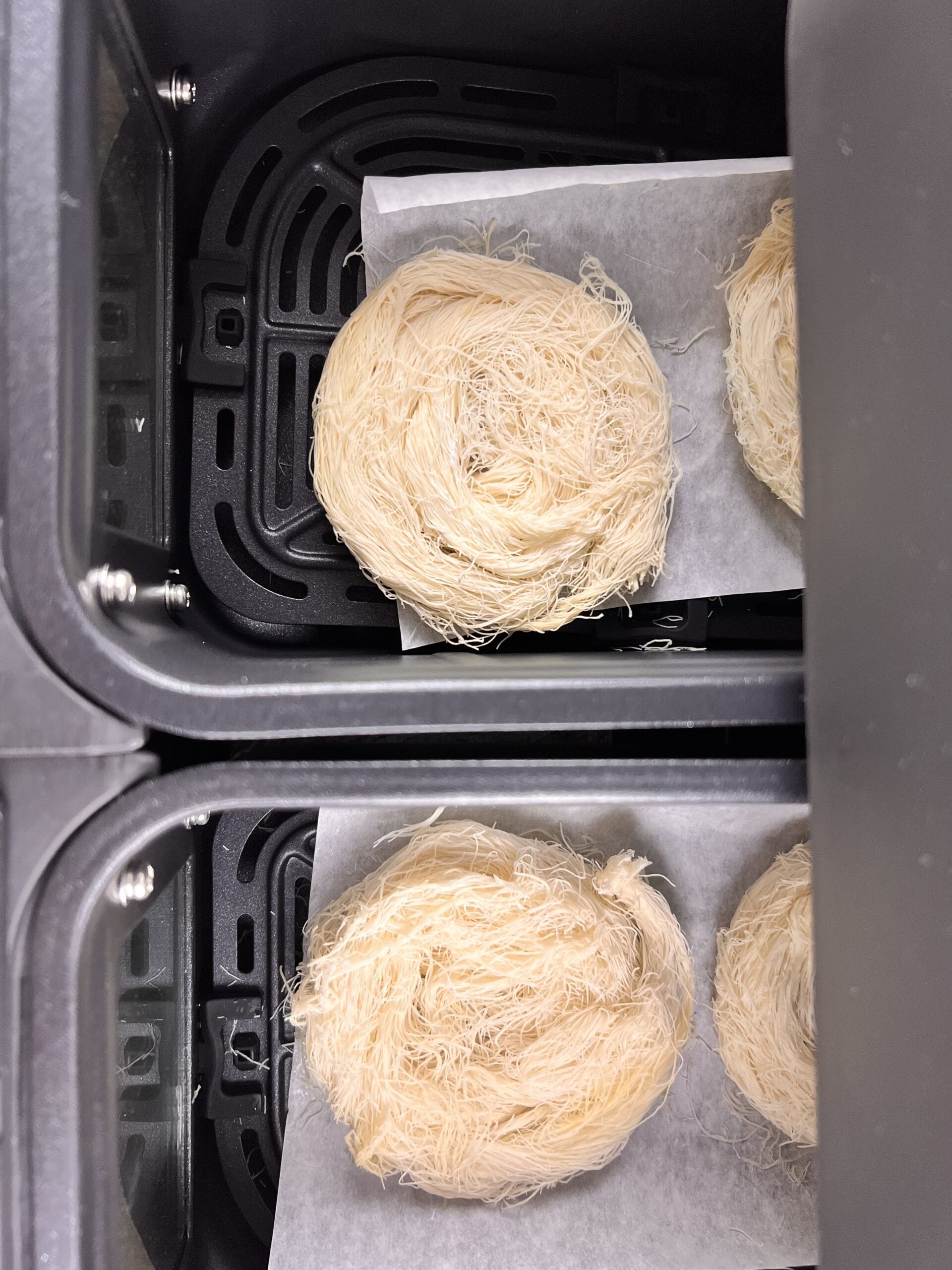 Air fried kataifi pastry nests/sutarfeni in a air fryer basket