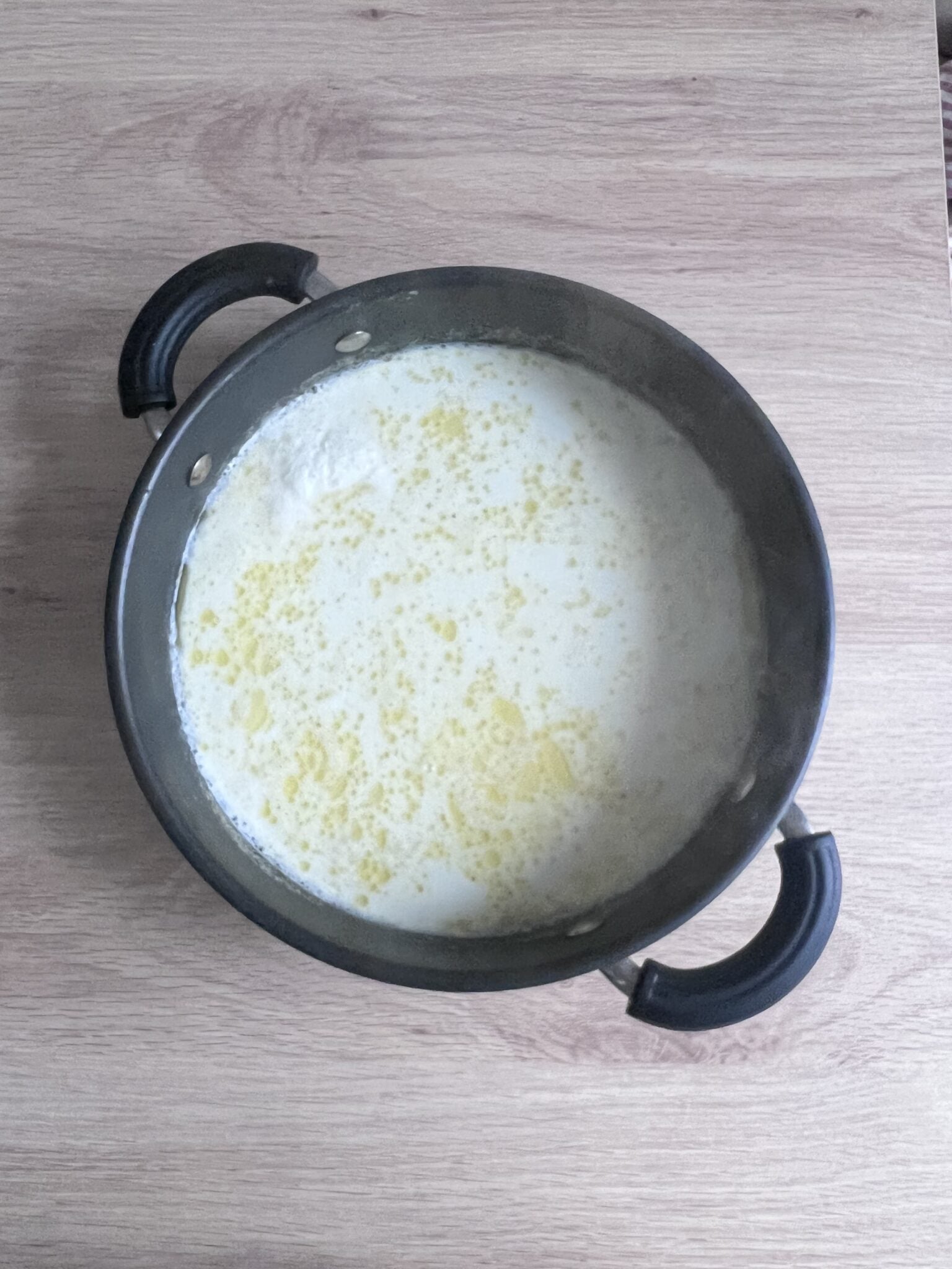 milk and semolina mixture cooking in a pan