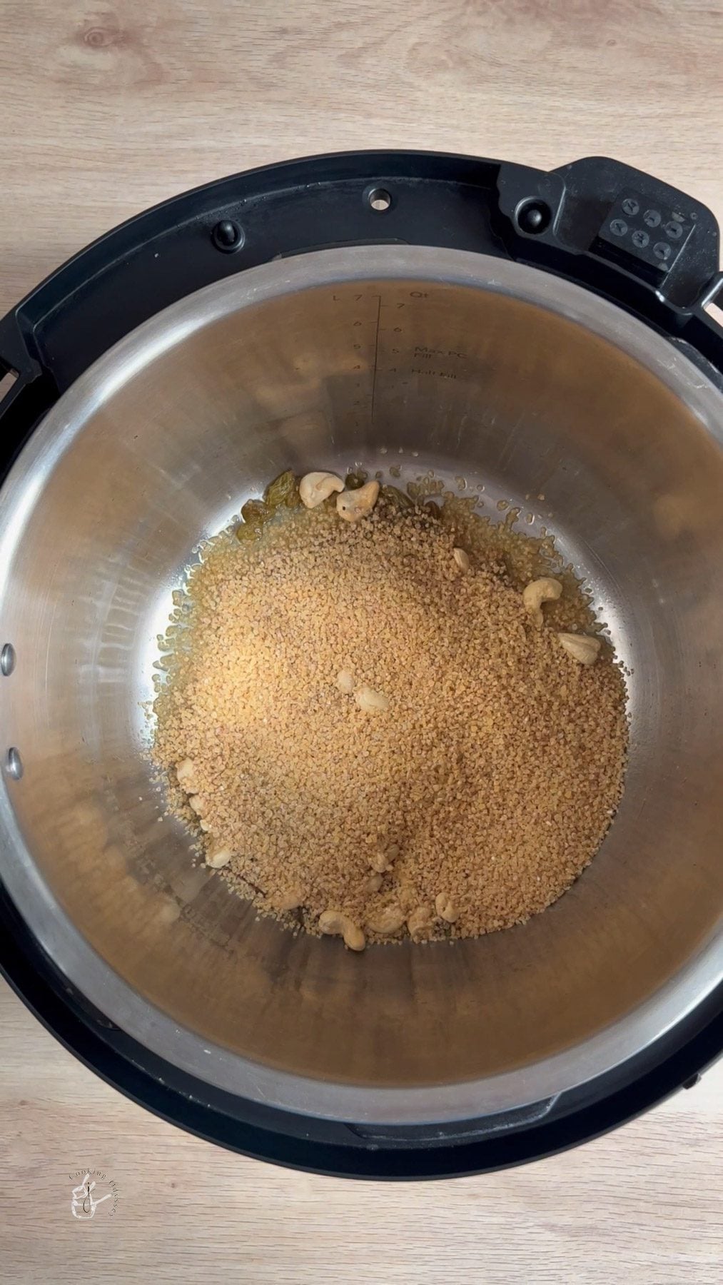 broken wheat added to the fried cashews, cinnamon and raisins