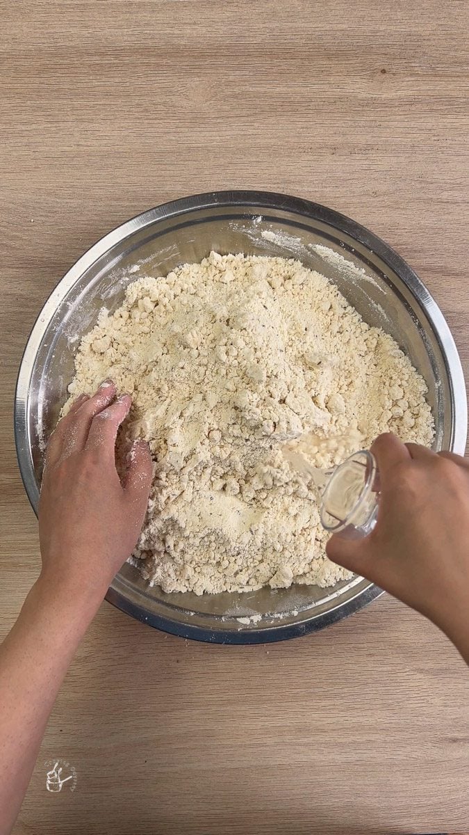 adding water into the dry flour
