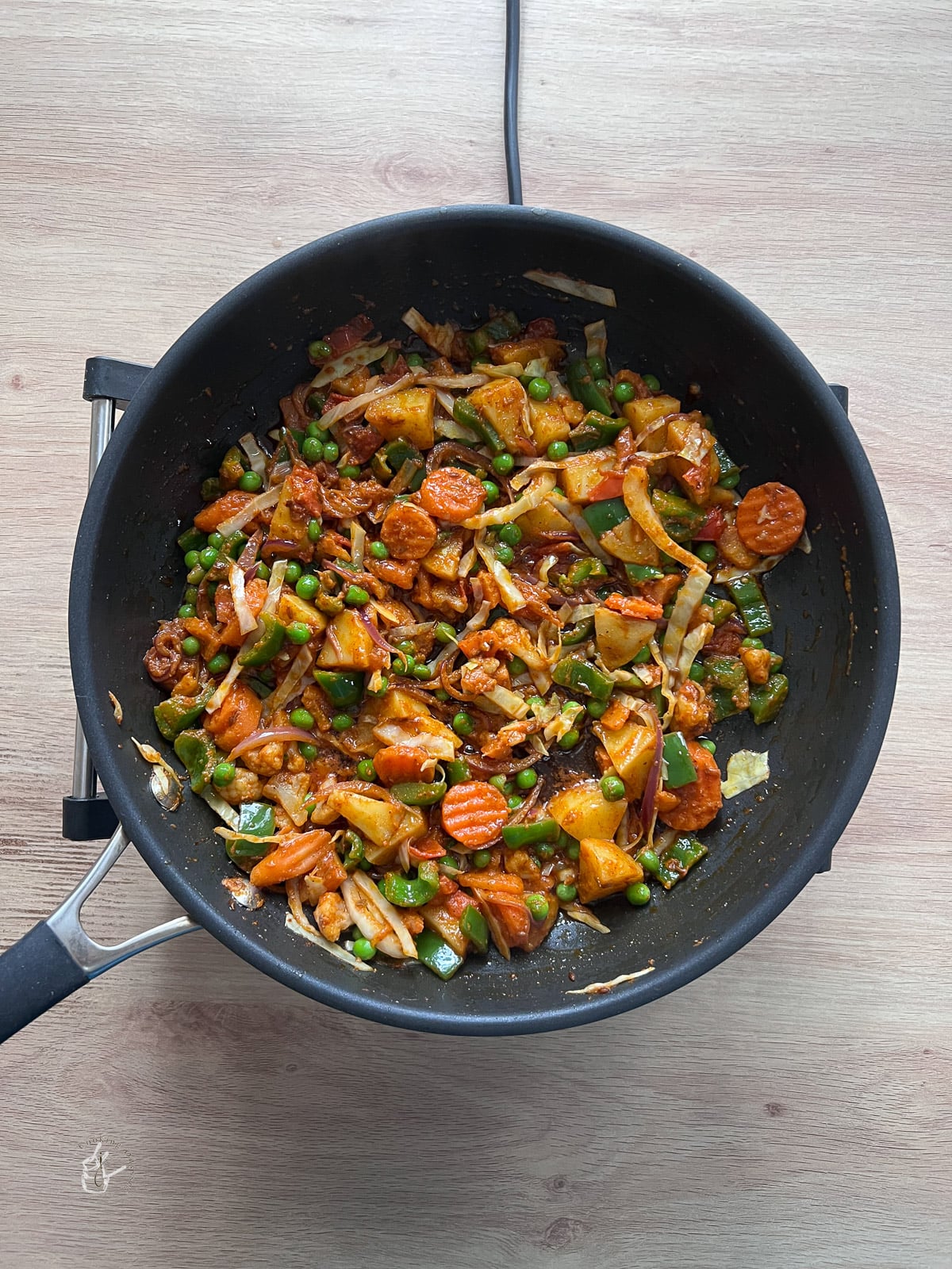Mixed vegetables cooking with spices in a pan. 
