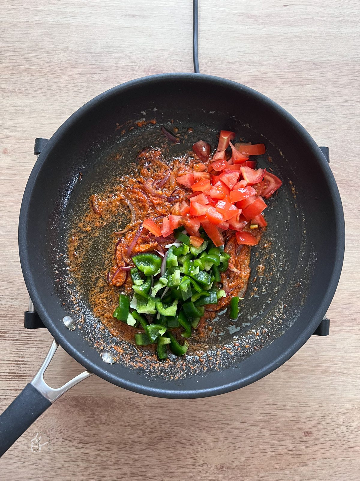 chopped tomatoes and capsicum added to the cooked onion mixture