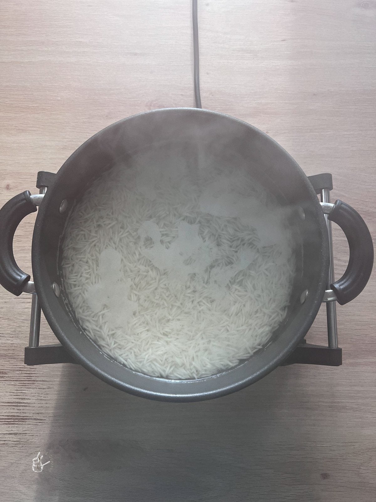 rice cooking in a wide mouth pan