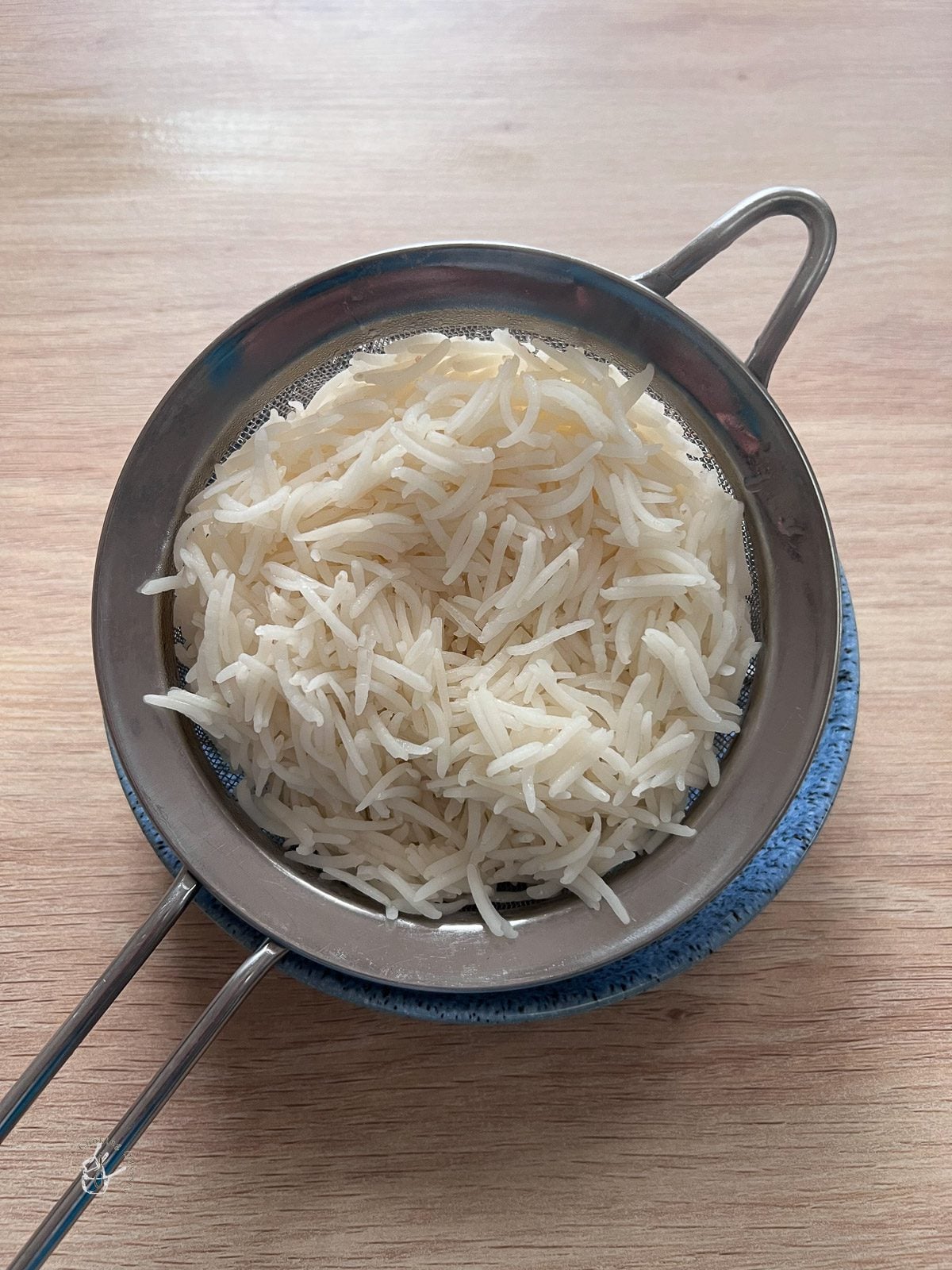 rice water draining in a strainer