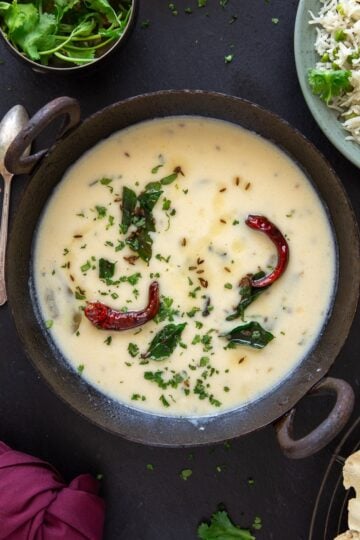 Gujarati white kadhi served with rice and papad.