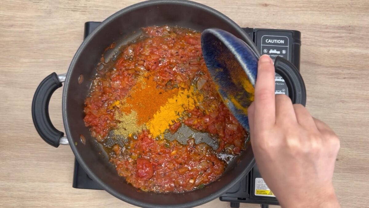 Tomatoes and spices powders in onion mixture