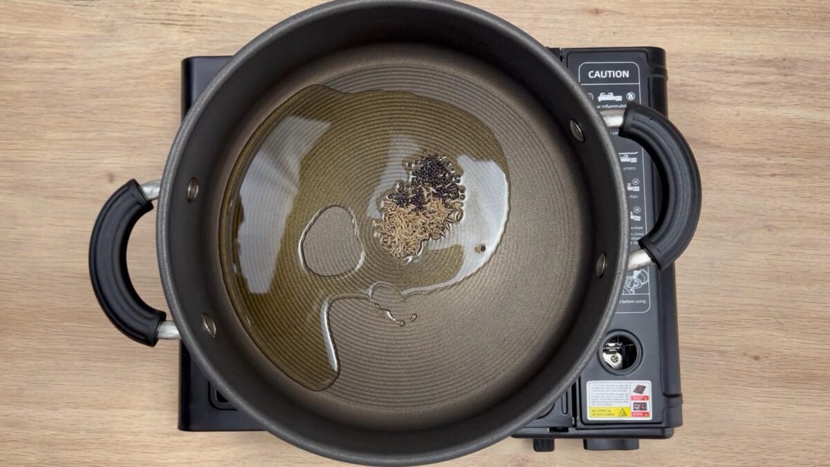 oil and whole spices in a pan