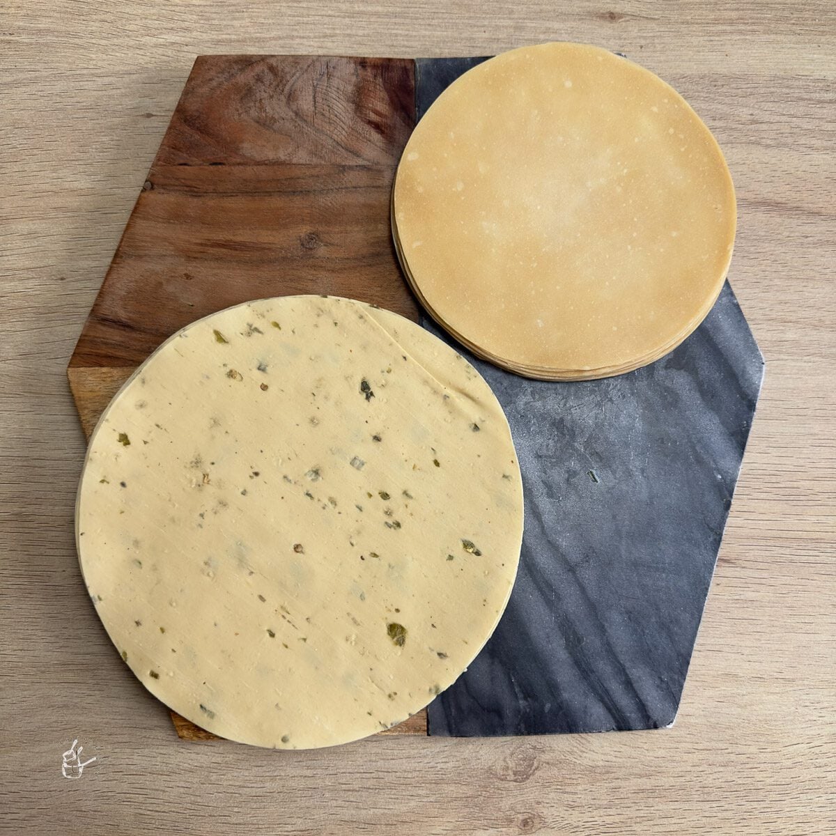 raw or uncooked poppadoms on a chopping board 