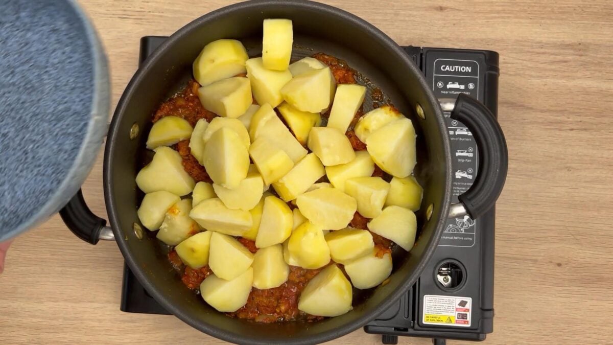 boiled potatoes added to the onion tomato mixture