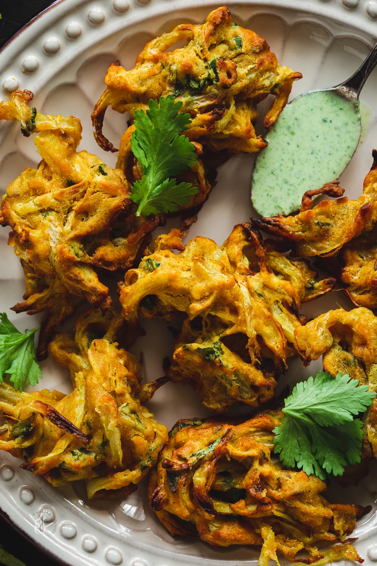 fully cooked air fryer onion bhajis served with indian mint sauce 