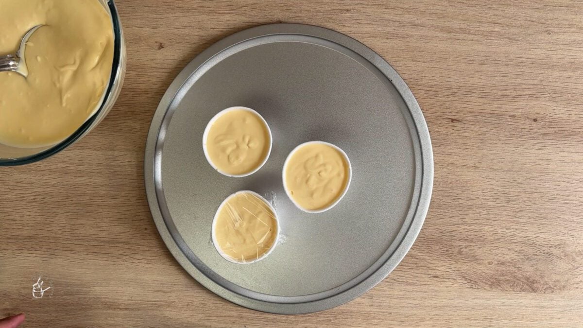 mango kulfi mixture poured in to the kulfi moilds