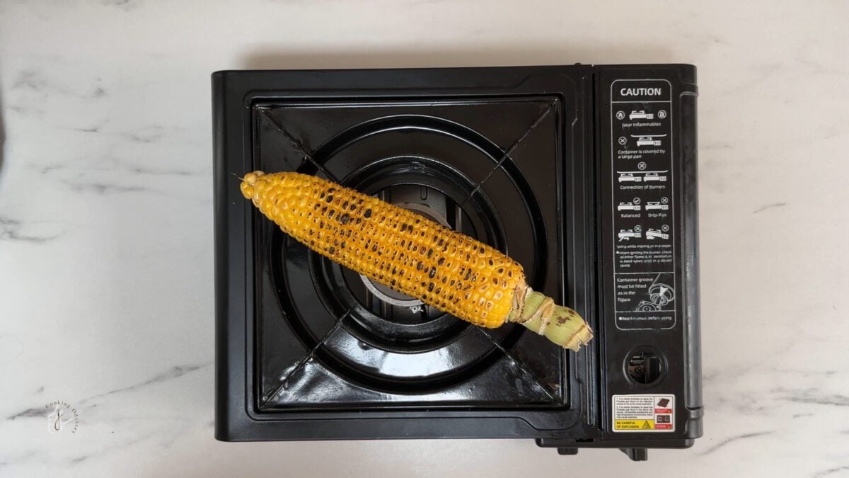 corn being roasted on the stove