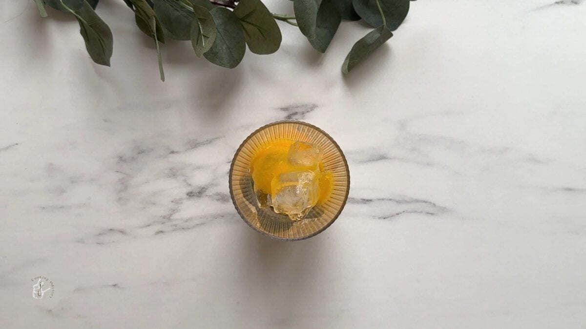 mango juice added to the glass 