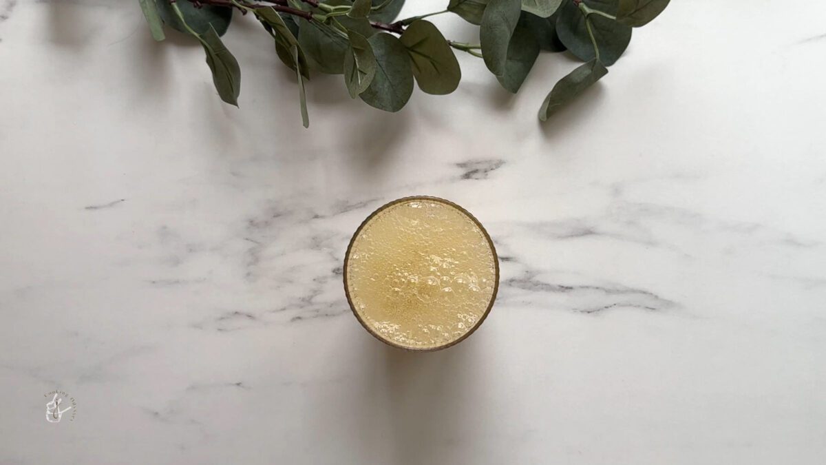 a glass of mango mocktail on a kitchen countertop
