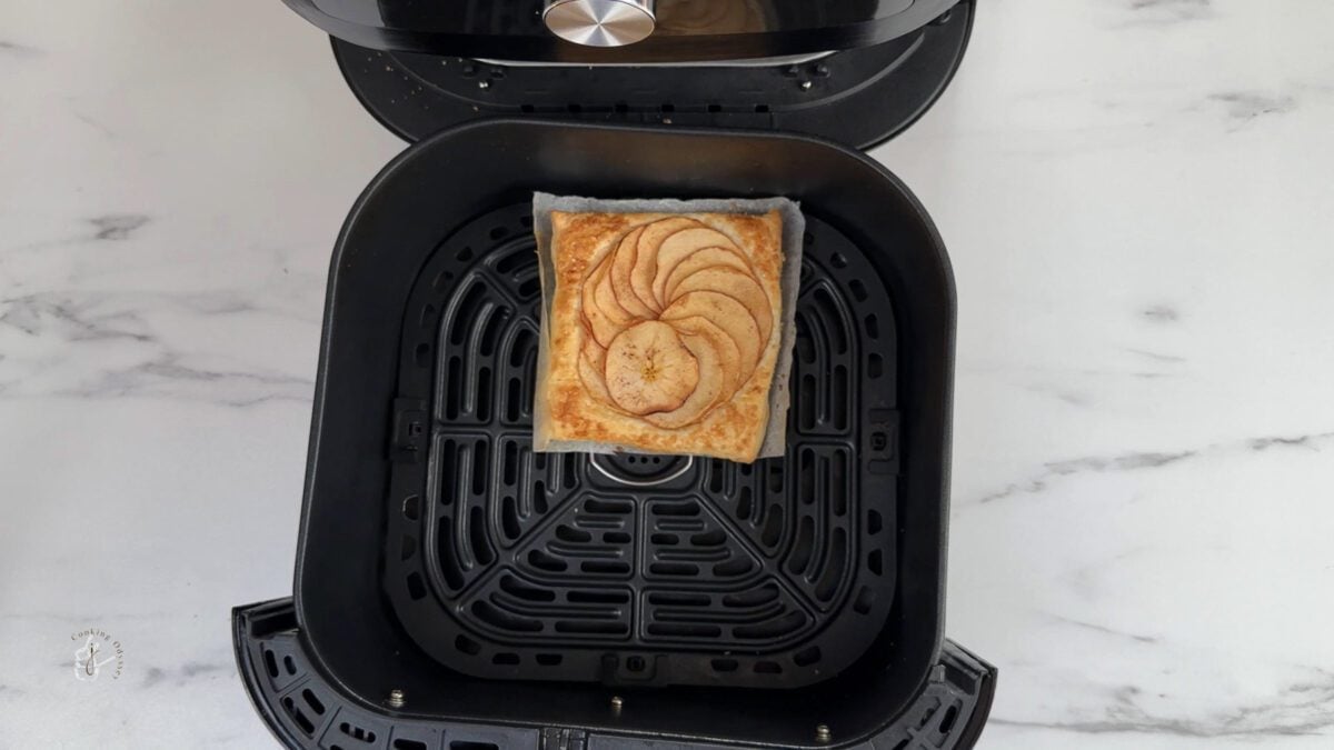 cooked vegan puff pastry apple tart in the air fryer basket