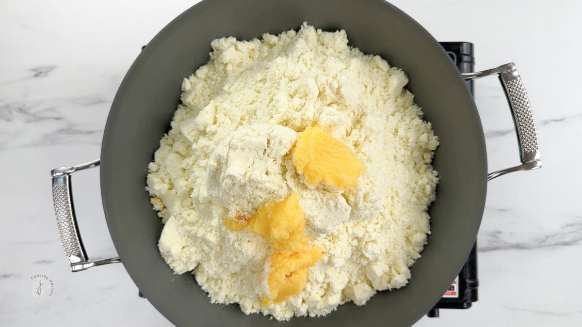 ghee added to the milk powder in a pan