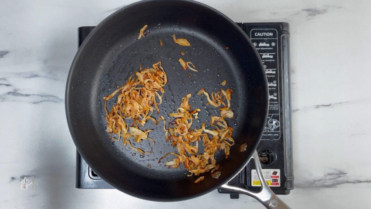 caramelised onion slices in the pan