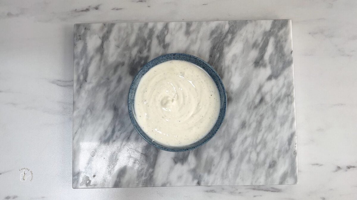 Middle eastern yogurt sauce in a blue bowl ready to serve