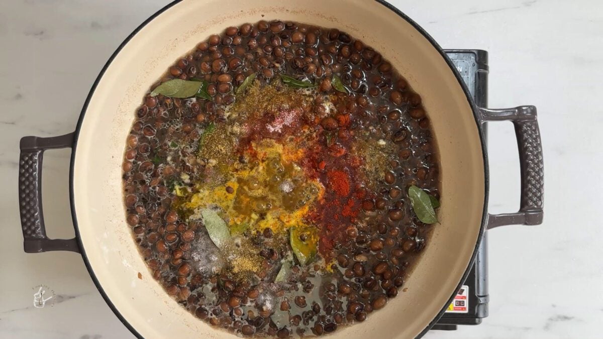 spice powders added to the boiled tuver in a pan