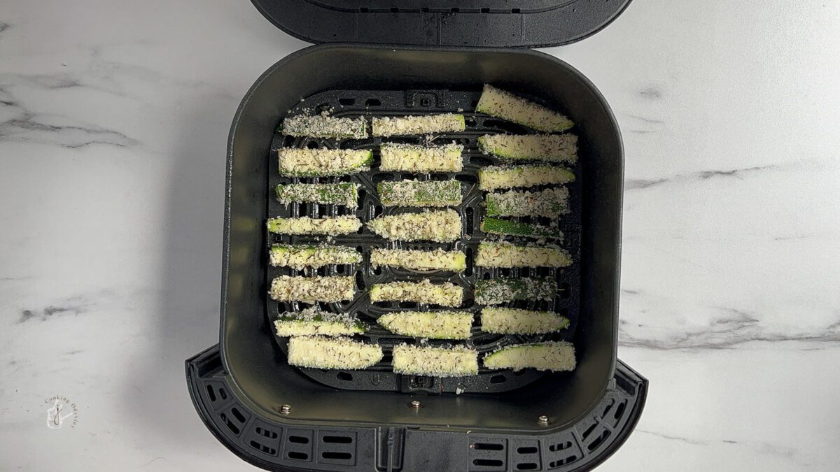 Breaded zucchini fries in the air fryer basket