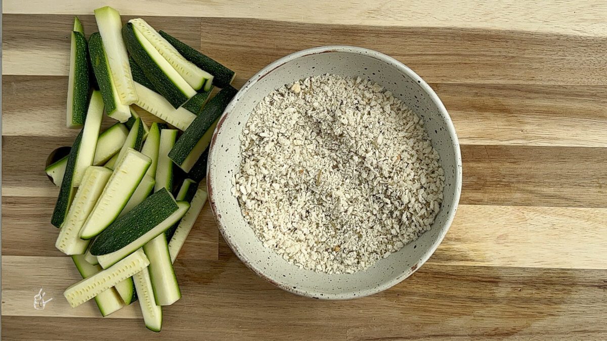 panko breadcrumbs placed in a bowl next to cut zucchini to make air fryer zucchini fries no egg